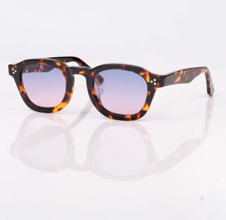 Sunglasses with tortoiseshell frame and purple lenses on a white background