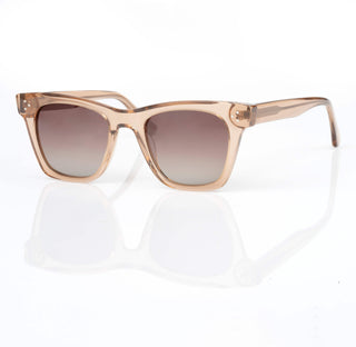 Sunglasses with a beige frame and gradient lenses on a white background