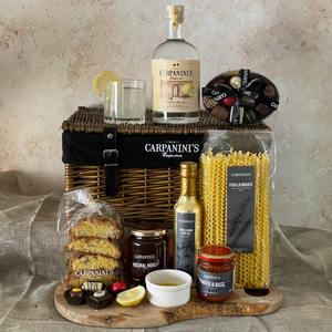carpaninis wicker hamper with gin bottle glass chocolates cantucci honey olive oil sauce and pasta in brown