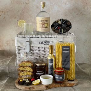 carpaninis wicker hamper with gin bottle glass chocolates cantucci honey olive oil sauce and pasta in white