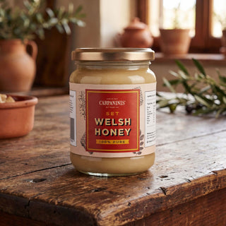 A jar of Carpaninis Welsh set honey on a wooden table 