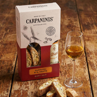 A Carpaninis cantucci and vin santo gift set on a wooden table