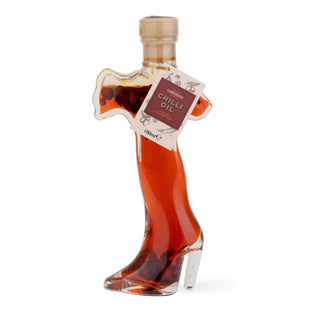 Bottle of Chilli Oil shaped like a high-heeled shoe on a white background