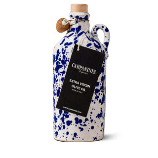 Ceramic olive oil bottle with blue splatter design and 'Carpaninis' label on a white background
