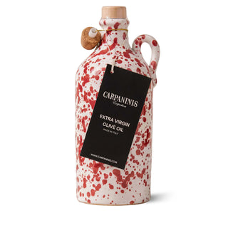 A handmade bottle of olive oil with red splatter paint