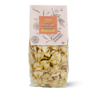 Bag of ribbon pasta with a decorative label on a white background
