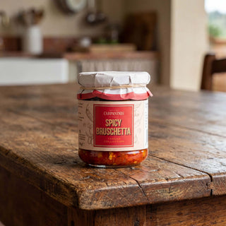 Jar of Carpanini Spicy Bruschetta on a wooden table with a kitchen background