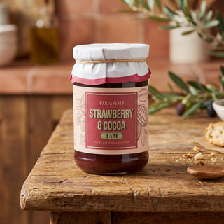 A jar of Carpaninis strawberry jam on a wooden table