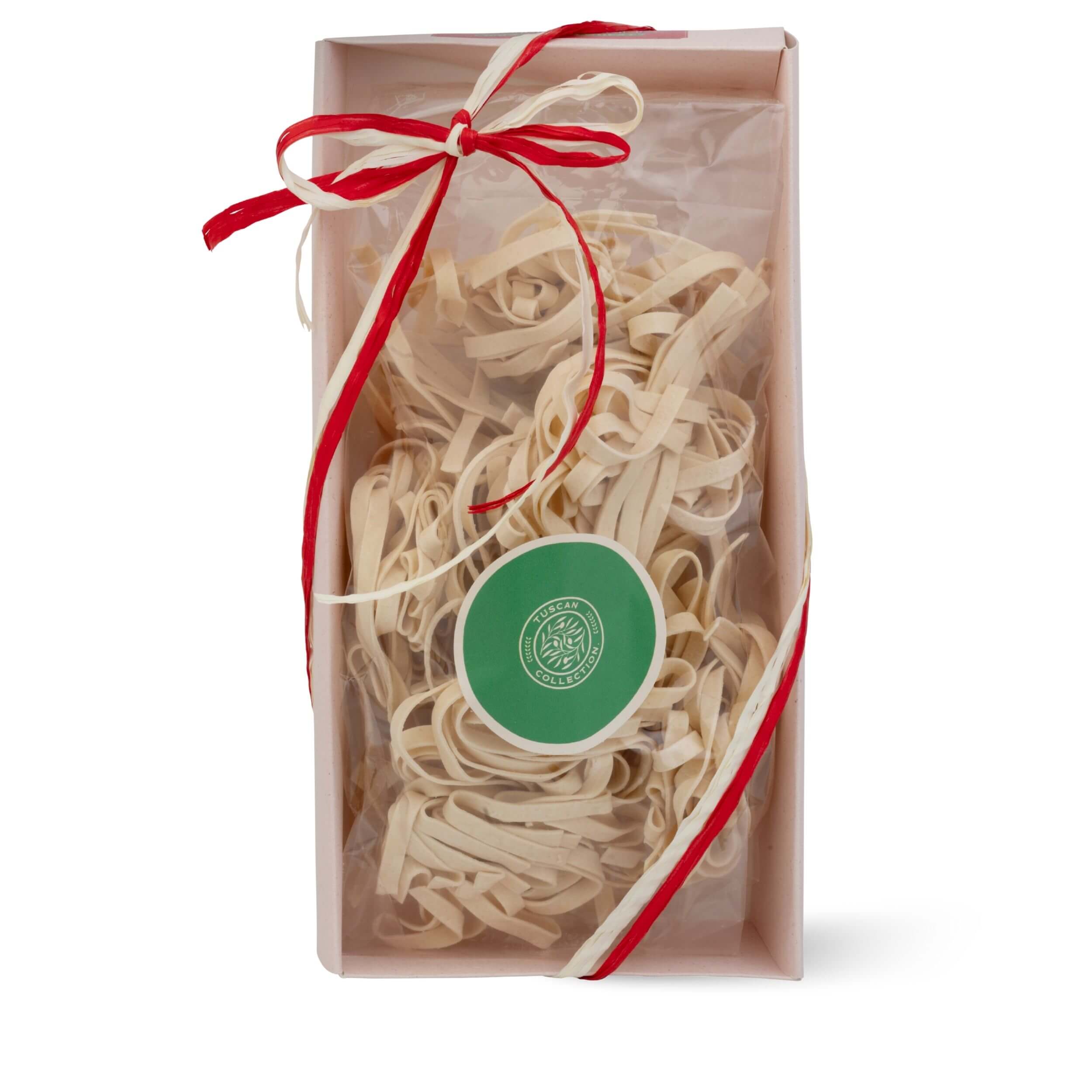 Tagliatelle pasta tray with a red ribbon and green label on a white background