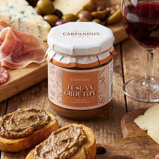 A jar of Carpaninis Tuscan crouton spread surrounded by a charcuterie board