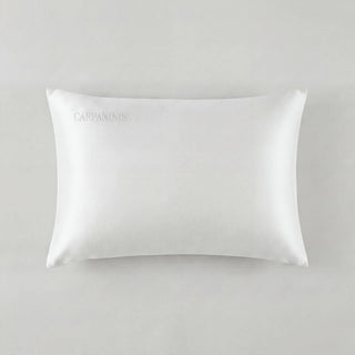 White satin pillowcase with 'Carpanolis' branding on a light gray background