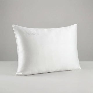 White silk pillow on a gray background