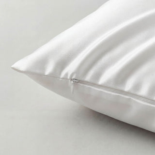White silk pillow on a light gray background