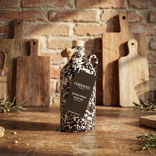 A handmade bottle of olive oil on. awooden table