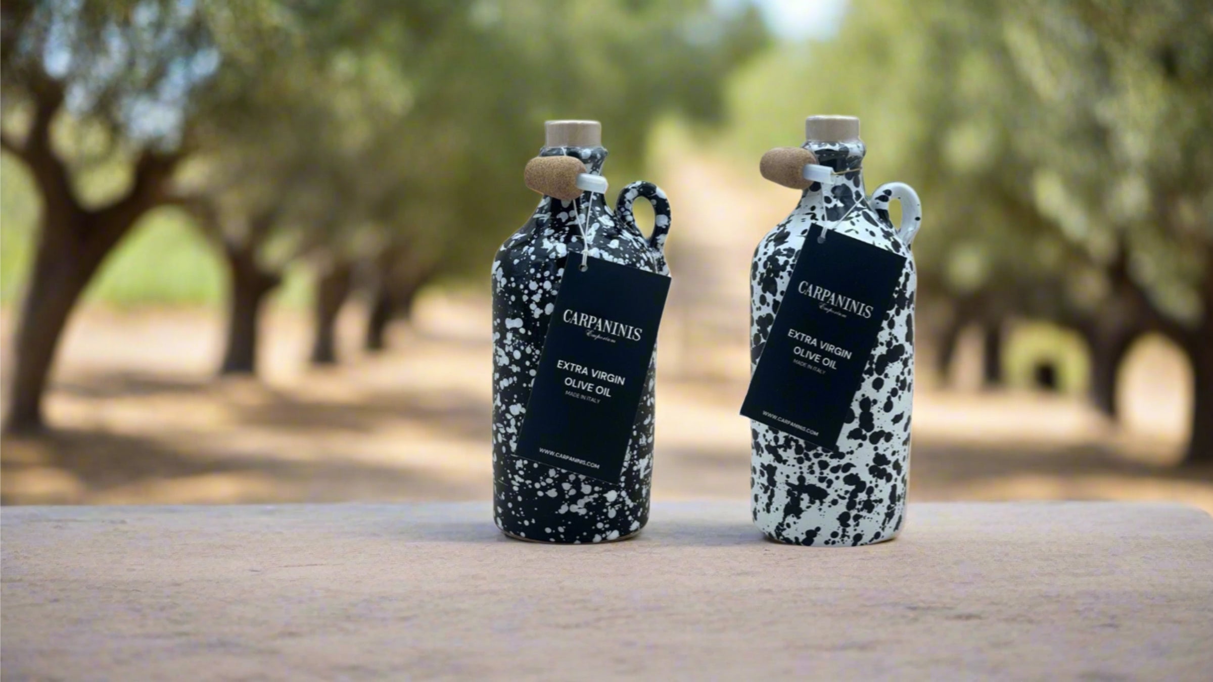Two bottles of Carpaninis  handcrafted ceramic extra virgin olive oils