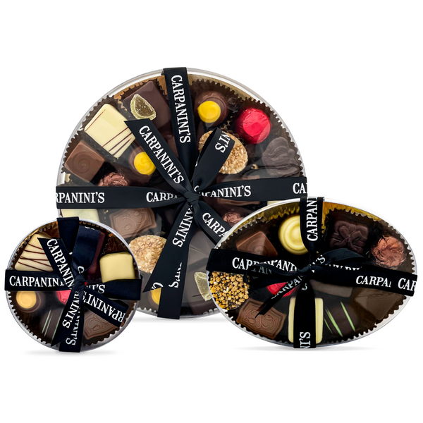 carpaninis medium large and small round clear boxes of assorted belgian chocolates with black ribbon