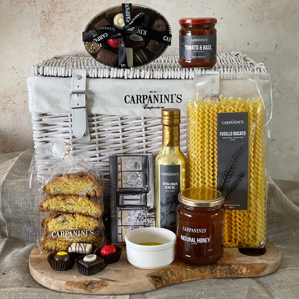 carpaninis wicker hamper with chocolates sauce cantucci chocolate bar olive oil honey and pasta in white