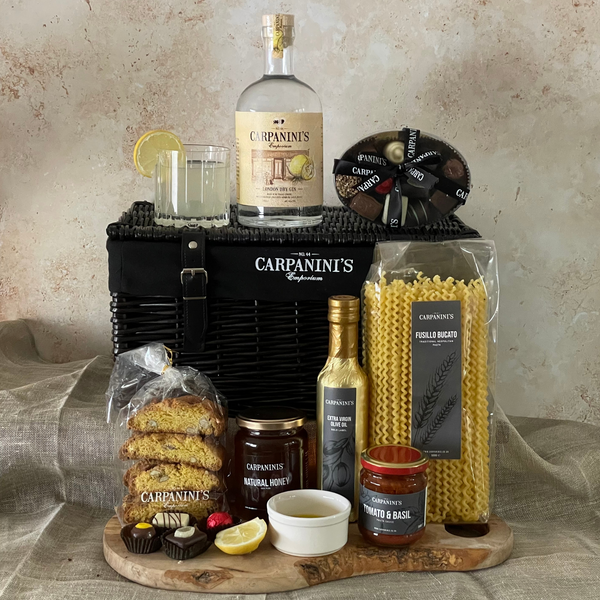 carpaninis wicker hamper with gin bottle glass chocolates cantucci honey olive oil sauce and pasta in black