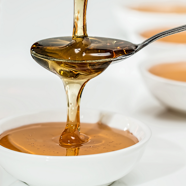 carpaninis honey being poured over a spoon into a bowl