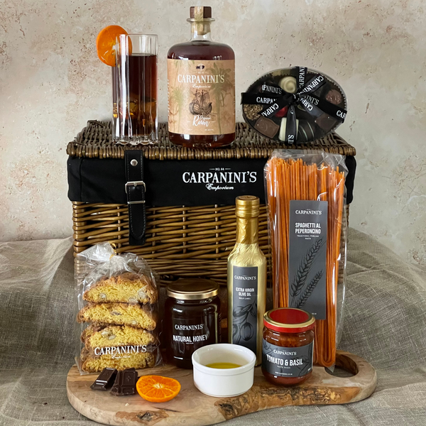 carpaninis wicker hamper with rum bottle glass chocolates cantucci honey olive oil sauce and pasta