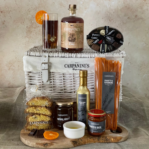 carpaninis wicker hamper with rum bottle glass chocolates cantucci honey olive oil sauce and pasta in white